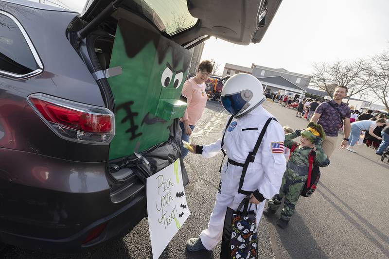 Lorenzo Chavez, 10, digs deep into Frank’s nose for a treat at the Sauk Valley Bank booth Tuesday, Oct. 29, 2024, during Sterling PD’s trunk or treat. The event featured local departments, businesses and organizations handing out candy and info on their services.