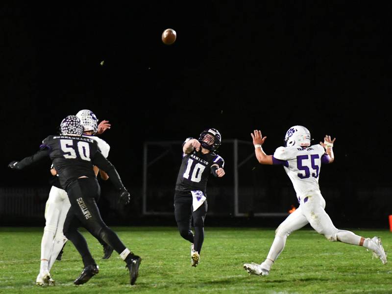 Manteno quarterback Connor Harrod (10) throws a pass as Wilmington pass rusher Logan Van Duyne (55) closes in on him during the 2024 ICE Conference meeting between the Panthers and Wildcats.