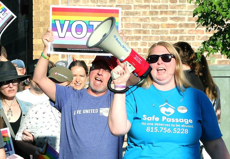 Participants march down the sidewalk on East Locust Street Thursday, June 23, 2022, during a parade to celebrate Pride month in DeKalb. The function included a short parade through downtown and a showing of the movie “Tangerine,” with a panel discussion afterwards at the Egyptian Theatre.