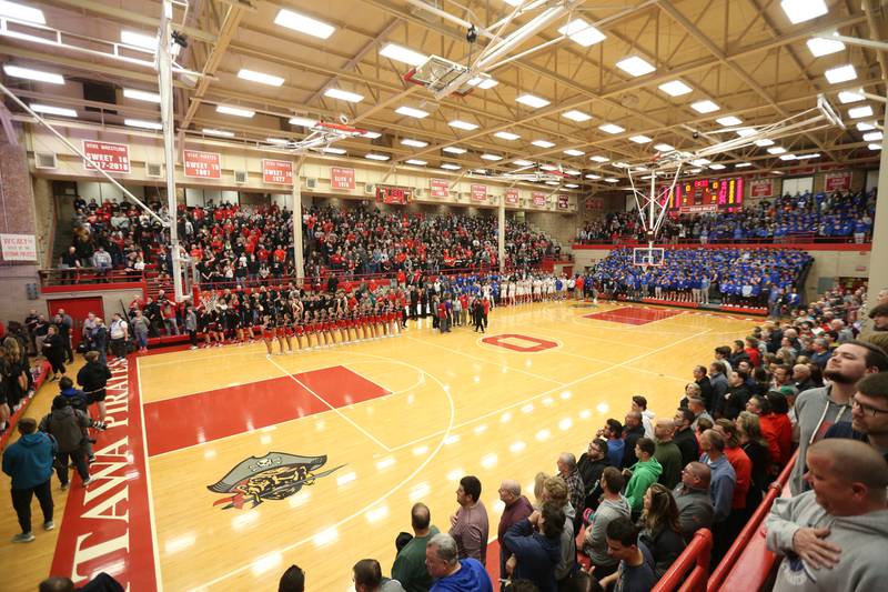 A sold out Kingman Gymnasium, with a capacity of 1,400 fans from Marmion Academy and Metamora High School stand for the National Anthem during the Class 3A Super-Sectional on Monday, March 6, 2023 at Ottawa High School.