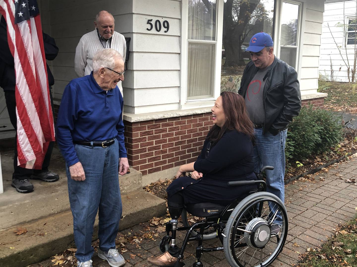 Edward “Bud” Berthond, greets Sen. Tammy Duckworth ahead of his 103rd birthday later this month with his friend, Ole Sinberg and her husband, Bryan Bowlsbey, looking on. Duckworth stopped at his Fox River Grove home on Friday, Nov. 4, 2022.