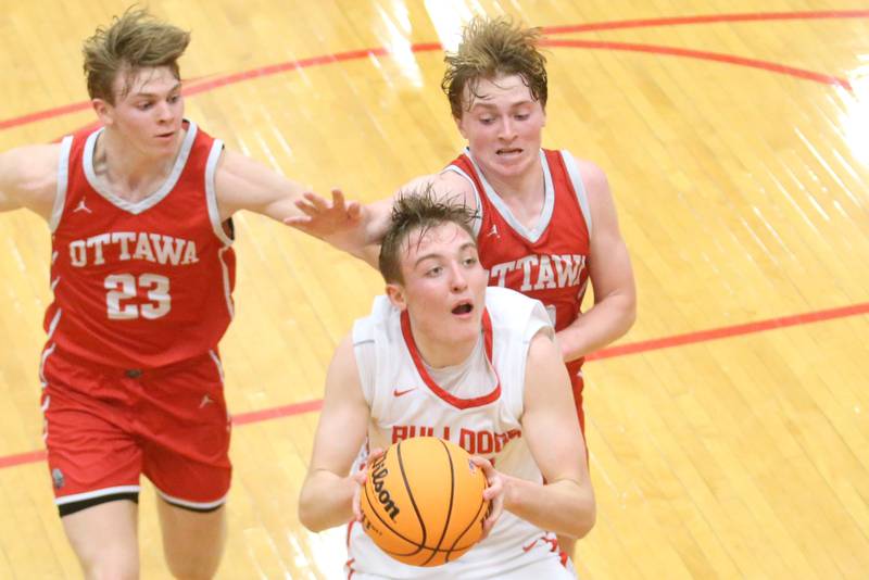 Streator's Nolan Lukach drives to the hoop as Ottawa's Owen Sanders and Evan Snook defend during the Class 3A Regional semifinal game on Wednesday, Feb. 26, 2025 in Sellett Gymnasium at L-P High School.