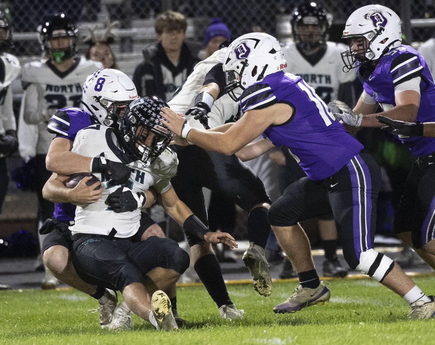 Dixon’s Bene Baratta hauls down Woodstock North’s Parker Halihan Friday, Oct. 31, 2025, in the Class 4A football first round playoffs.