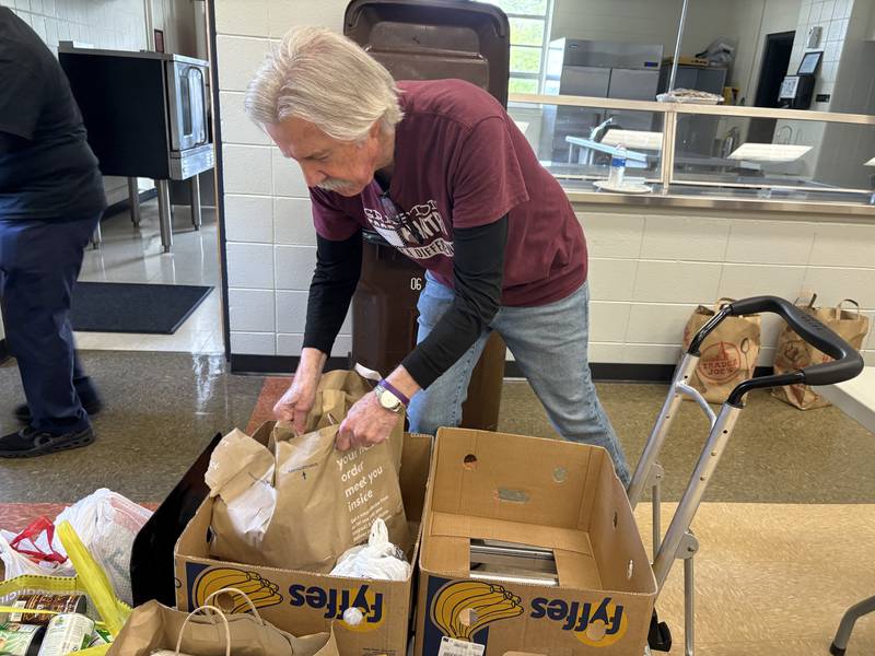 Grafton Food Pantry Volunteer Hans Stucki grabs bags of food at the Huntley Park District Saturday May 9, 2026.