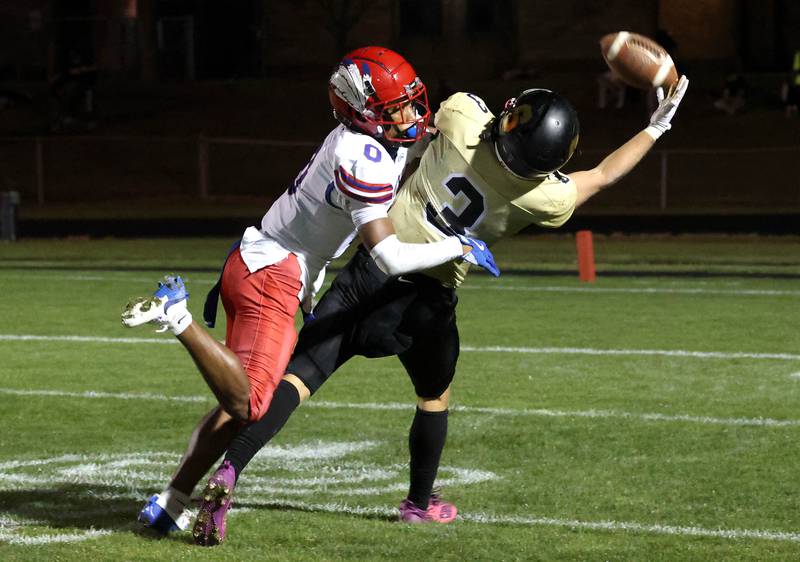Sycamore's Carter York tries to make a catch as Cahokia's Antonio Morris provides the coverage Friday, Oct. 25, 2024, at Sycamore High School.
