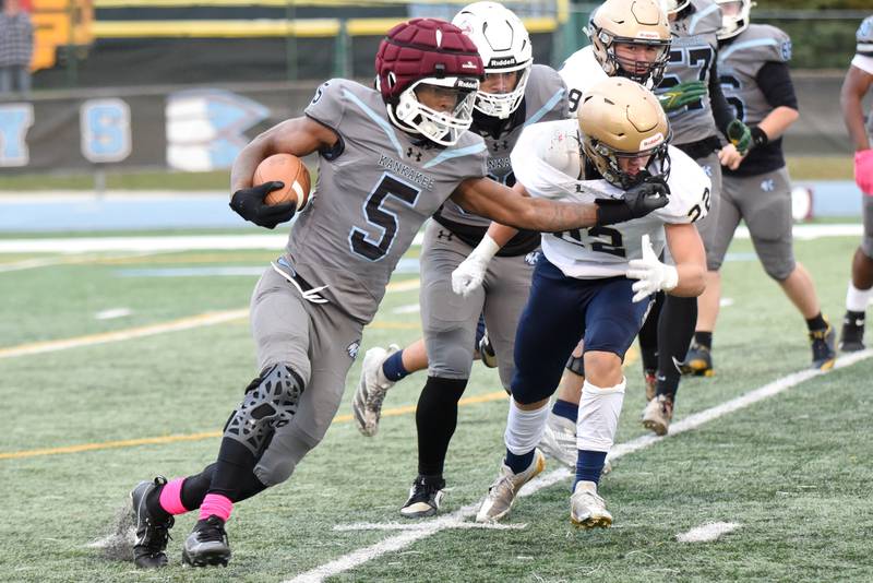 Kankakee's Jaymari Hairston (5) stiff arms Lemont's Brady Collins during an IHSA Class 5A playoff game at Kankakee Saturday, Nov. 1, 2025.