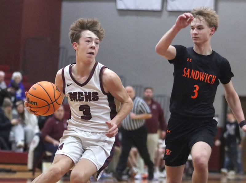 Marengo’s Caden Bezik, left, looks for an option as Sandwich’s Wyatt Koley defends in varsity boys basketball action on Saturday, Jan..24, 2025, at Marengo High School in Marengo.