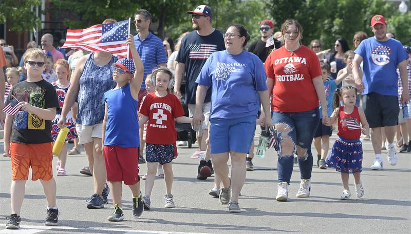Local school children carry the Red, White and Blue as they participate Monday, May 30, 2022, in the annual Ottawa Memorial Day parade.