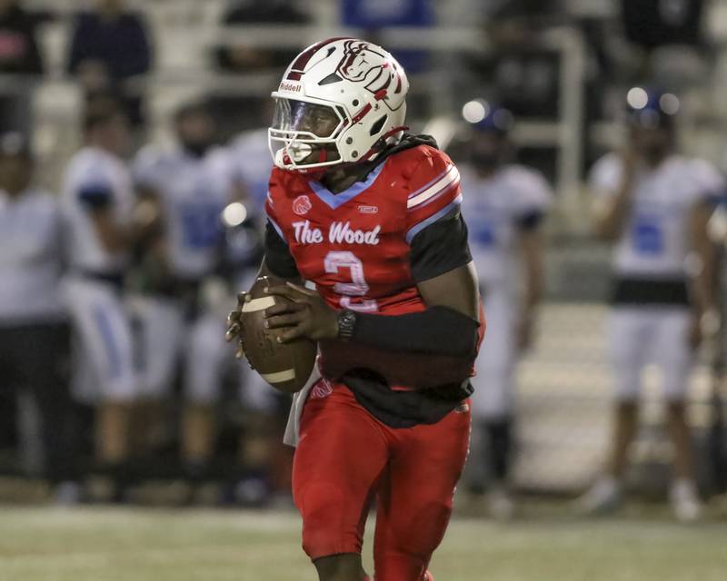 Kenwood Academy's Kenyonte Louis scrambles while looking downfield during football game between St. Francis at Kenwood Academy on Thursday, Aug 28, 2025  in Chicago.