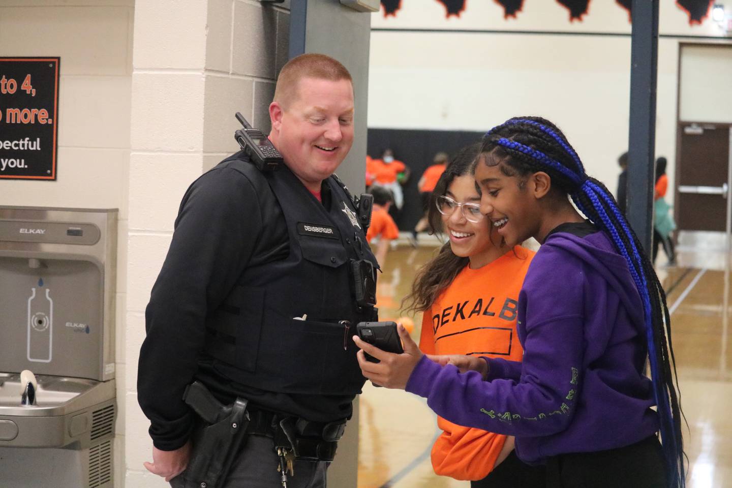 School Resource Officer Tony Densberger (left) is seen Oct. 20, 2022 with Keniyah Stevenson and Briana Elion (right) at Clinton Rosette Middle School in DeKalb.