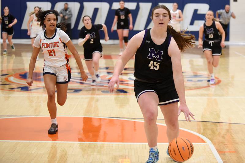 Manteno's Emily Horath, right, leads a fast break as Pontiac's Trinity Miller chases during the IHSA Class 2A Pontiac Sectional championship Thursday, Feb. 26, 2026.