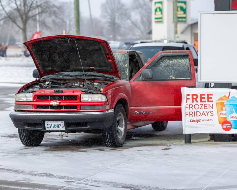 Vehicle involved on the scene of an internal electrical fire of a vehicle near a gas pump sits extinguished, awaiting tow on Tuesday, December 30, 2025, at Casey's on 1100 Shooting Park Road in Peru. The fire was extinguished by 15-year-old driver Jesus Gonzalez of Streator.