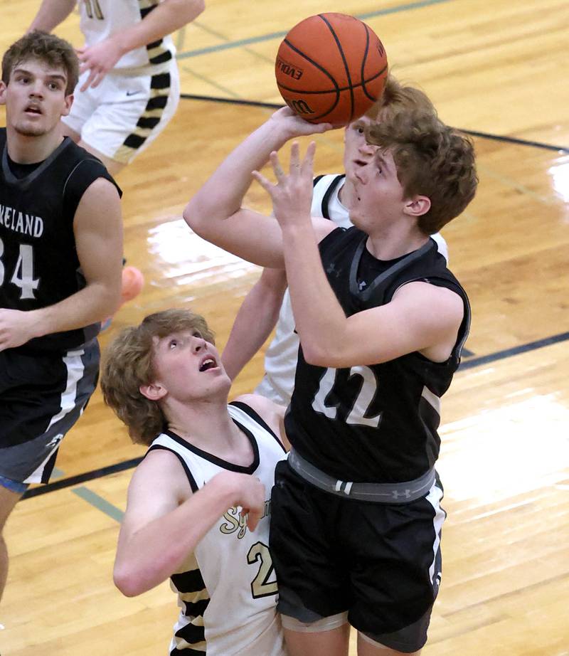 Kaneland's Johnny Spallasso shoots over Sycamore's Lucas Winburn as he goes to the basket during their game Friday, Feb. 10, 2023, at Sycamore High School.