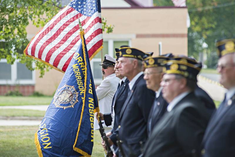 The honor guard for the Morrison American Legion stand at attention Sunday afternoon. The legion held a retirement of worn and faded American flags by honorably burning them.