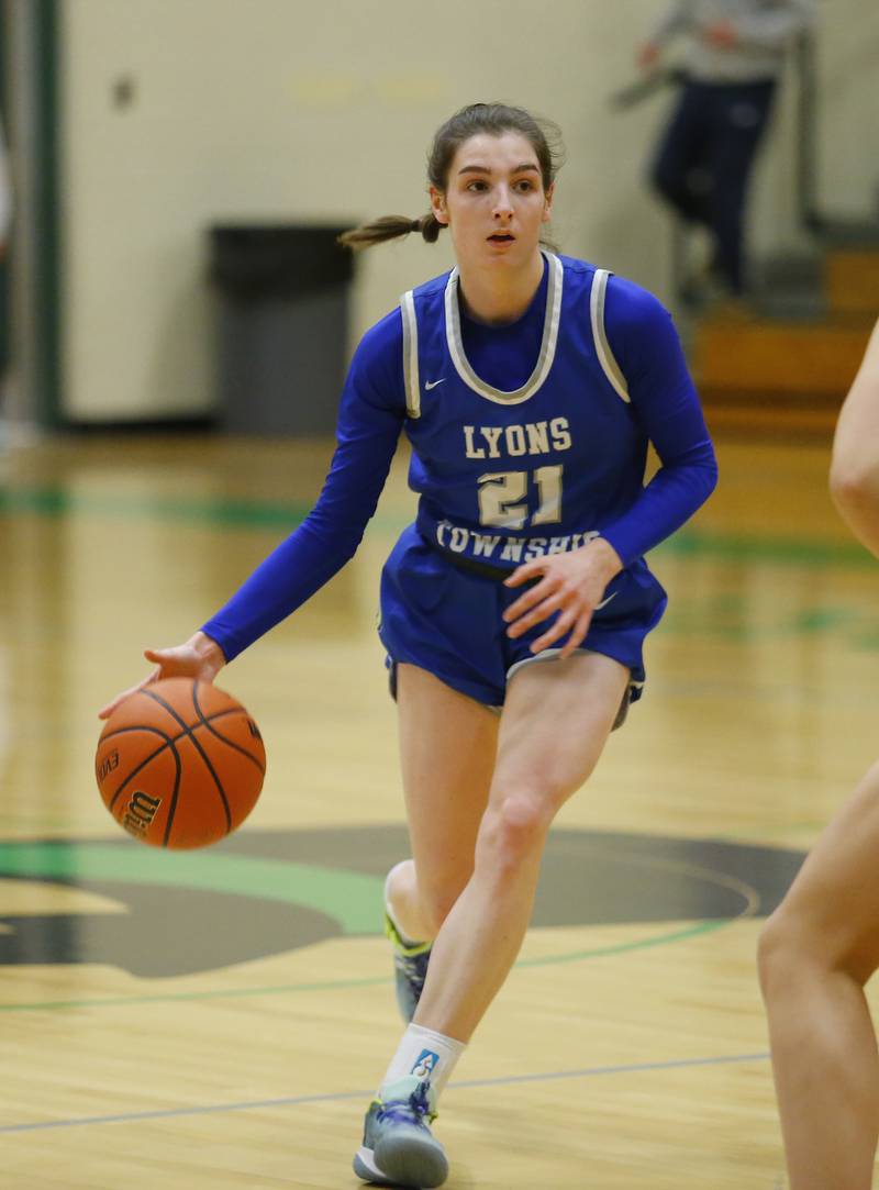 Lyons' Ally Cesarini (21) drives to the basket during the girls varsity basketball game between Lyons Township and York high schools on Friday, Dec. 16, 2022 in Elmhurst, IL.
