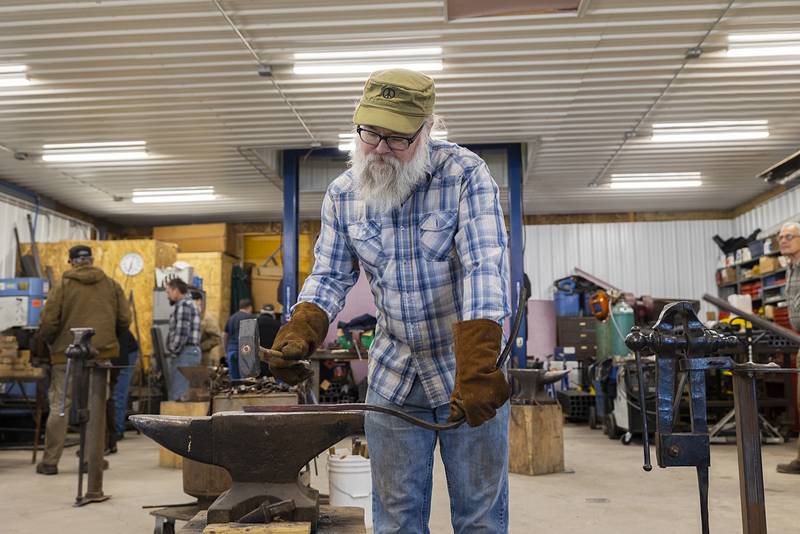 On Sunday, March 19, Mark Stach hammers out the bends and wrinkles in a twisted piece of metal plucked from the bottom of the Rock River during summer magnet fishing trips. With the help of Dixon shop owner Brian Cheshire, Stach has been straightening out the metal as an historical art project.