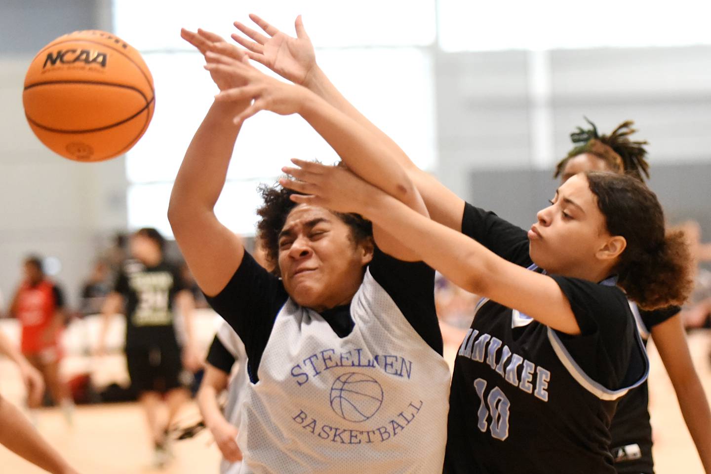 Joliet Central's Melani Tua-Link, left, and Kankakee's Amielya Taylor battle for a rebound during a game at the Kankakee Live event at the Genevra Walters Community Center Saturday, June 14, 2025.