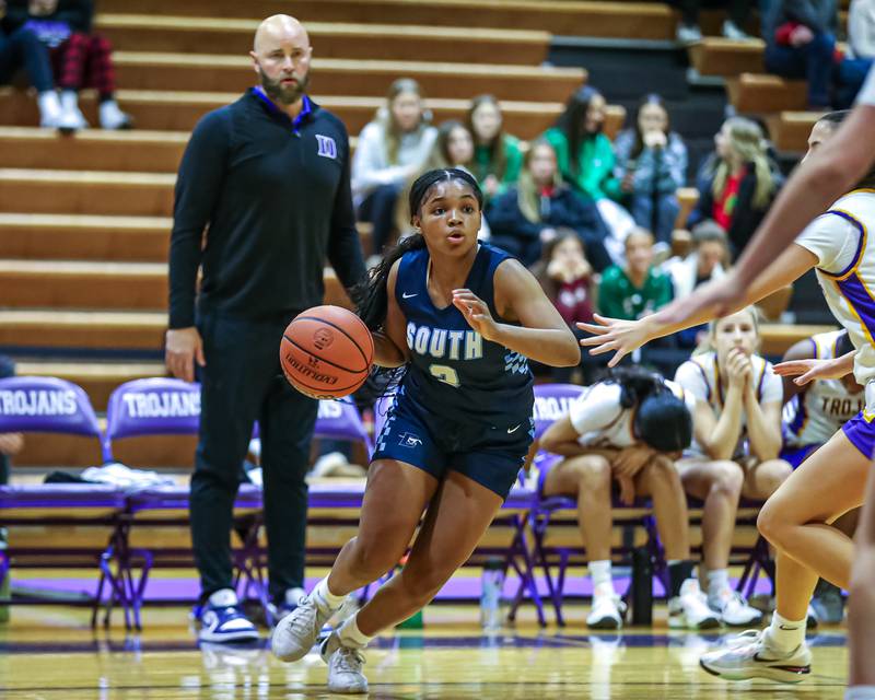 Downers Grove South's Jakylah Thomas (3) drives to the basket during girls basketball game between Downers Grove South at Downers Grove North. Dec 16, 2023.