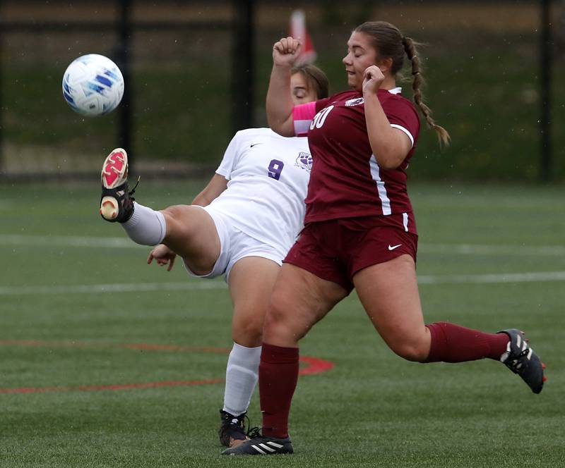 Hampshire's Isabel Morales kicks the ball away from Prairie Ridge's Grace Wolf during a Fox Valley Conference soccer game on Tuesday, April 16, 2024, at the MAC Athletic Complex in Crystal Lake.