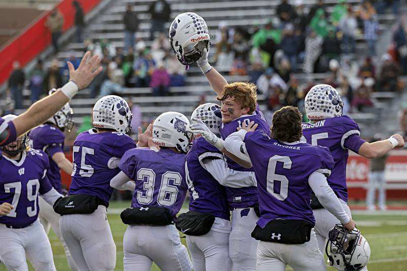 The Wilmington Wildcats celebrate their 28-3 win over Athens Friday, Nov. 24, 2023 in the 2A state football championship game at Hancock Stadium in Normal.