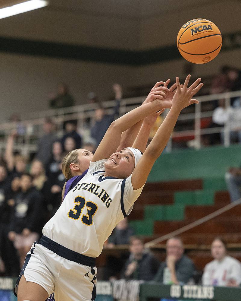 Sterling’s Joslynn James reaches for a rebound against Dixon Thursday, Feb. 27, 2025, during the Class 3A girls Sectional title at Rockford Boylan High School.