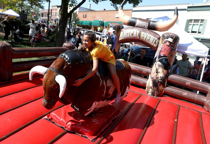 CarmilaTenorio rides a mechanical bull on Sunday, Sept. 14, 2025, during the annual Hispanic Connections Mexican Independence Day Celebration in the Historic Woodstock Square. The celebration featured music, food and culture.