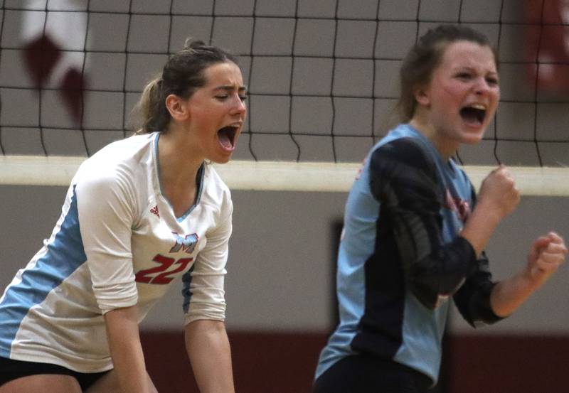 Marian Central’s Hadley Rogge, left, and Jilly Winkelman get revved up against Marengo in IHSA Class 2A Regional volleyball action on Monday, Oct. 28, 2024, at  Marengo High School  in Marengo.