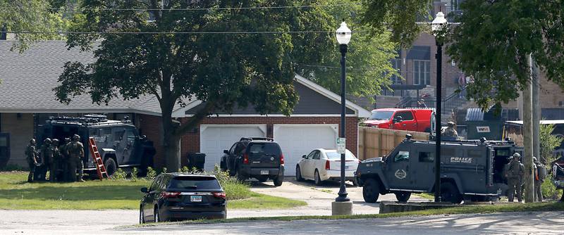 Law enforcement from area departments surround a home on Thursday, June 5, 2025, in the area of Venice Avenue and Court Street in McHenry.