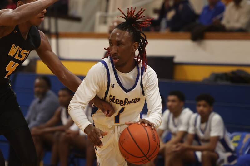 Joliet Central’s Jamarcho Holman drives to the basket against Joliet West.