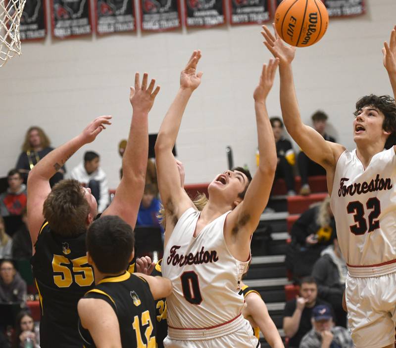 Forreston's Joseph Kolber (0) and Jonathan Milnes (32) reach for the ball against AFC on Saturday, Jan. 17, 2026 at Forreston High School.
