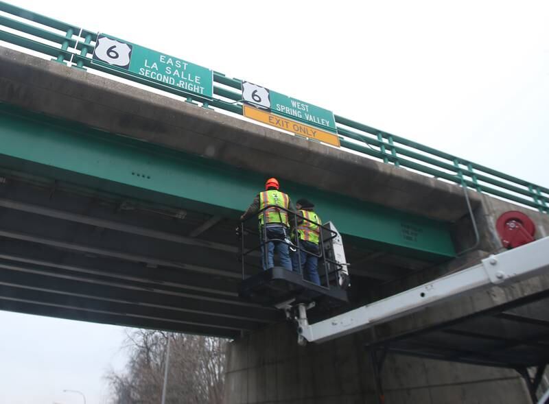 Illinois Department of Transportation workers inspect the 7th Street overpass on Tuesday, Dec. 20, 2022 in Peru. A large semi truck carrying an oversize load struck the bridge on Tuesday morning. IDOT and Peru Police were on the scene.