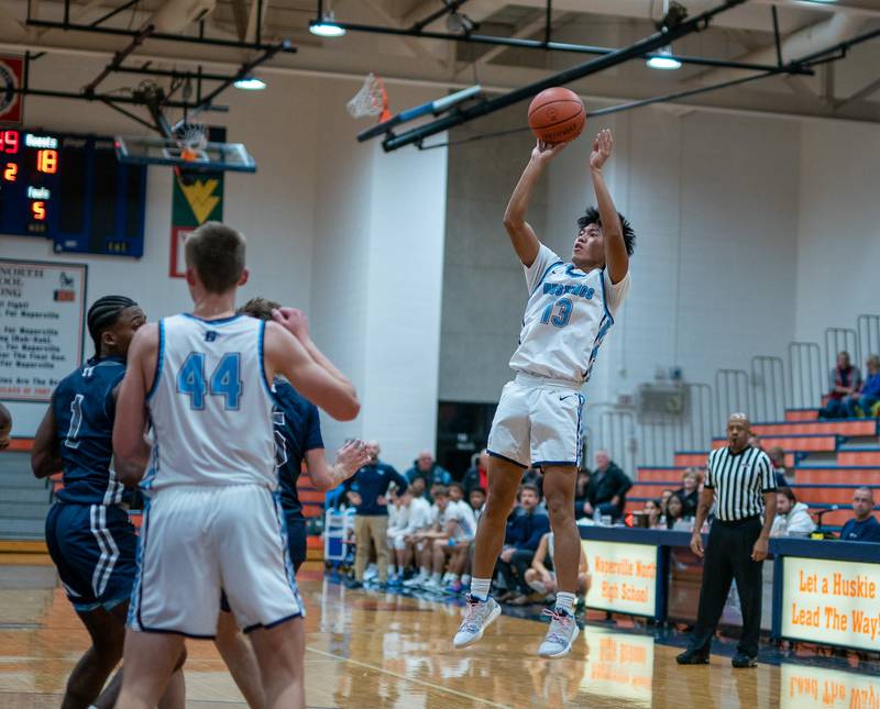 Downers Grove South's Ricard Gasmen (13) shoots a jumper against Oswego East during the hoops for healing basketball tournament at Naperville North High School on Monday, Nov 21, 2022.
