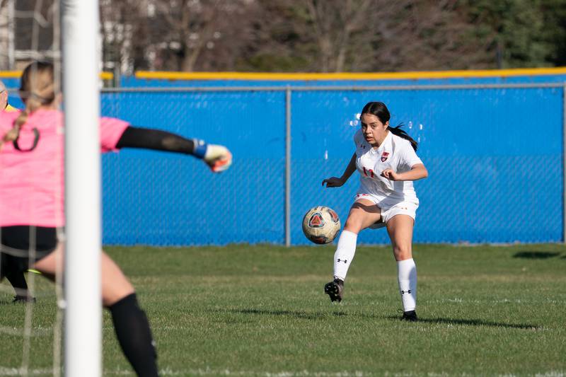 Oswego’s Dahlia Fuentes (12) shoots the ball against Oswego East during a soccer match at Oswego East High School on Thursday, Apr 6, 2023.