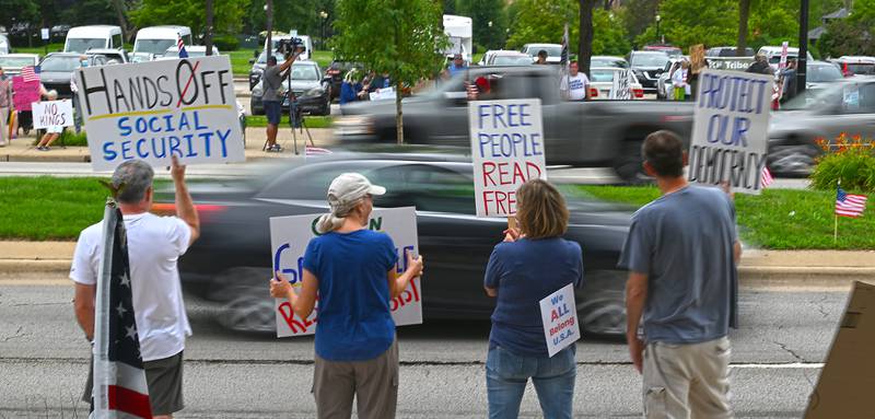 People line Kimball Street in Elgin during the "Good Trouble Lives On" protest Thursday.