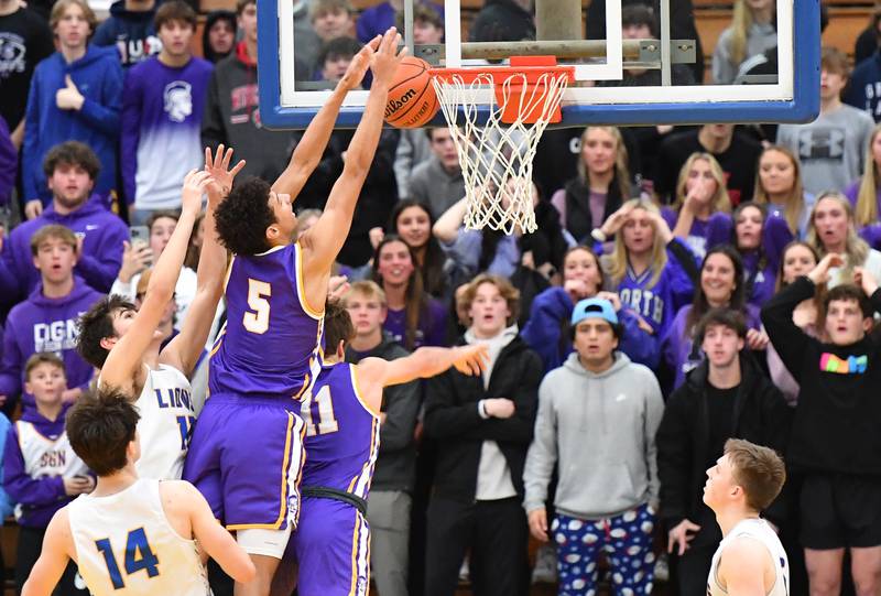 Downers Grove North's Jacob Bozeman (5) makes a last second attempt to score as the clock runs out in a game against Lyons Township on Jan. 6, 2023 at Lyons Township High School in LaGrange.