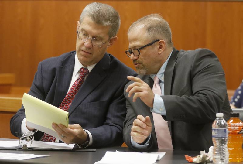 Defense attorney Matthew McQuaid  and Andrew Polovin talk during cross examination of Carol Ruzicka, a retired Illinois Department of Children and Family Services administrator, on the third day of the trial for the former Illinois Department of Children and Family Services employees Carlos Acosta and Polovin before Lake County Judge George Strickland on Wednesday, Sept. 13, 2023, at the McHenry County Courthouse. Acosta, 57, of Woodstock, and Polovin, 51, of Island Lake, each are charged with two counts of endangering the life of a child and health of a minor, Class 3 felonies, and one count of reckless conduct, a Class 4 felony, related to their handling of the AJ Freund case.