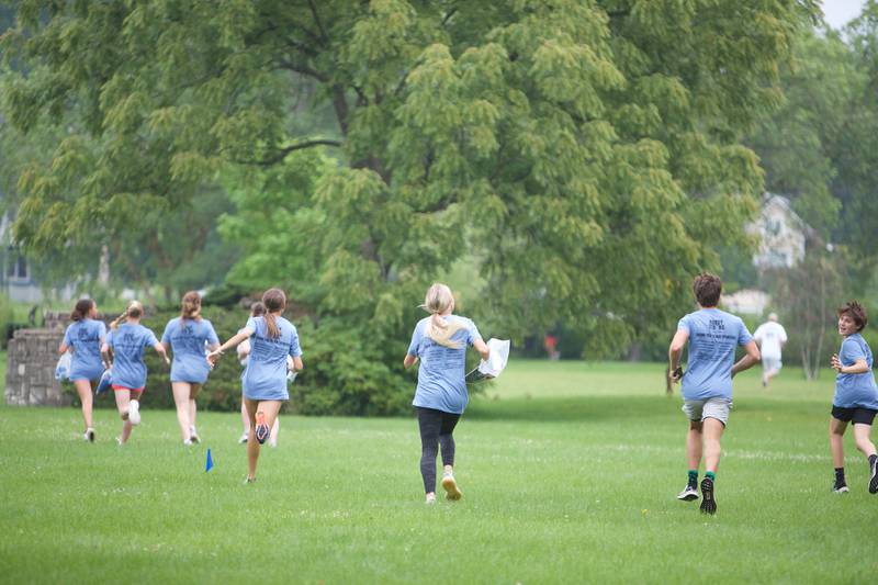 Participants running to stations at The Amazing Race Hardy Strong at Mt. St. Mary Park in St. Charles on Saturday, August 5, 2023