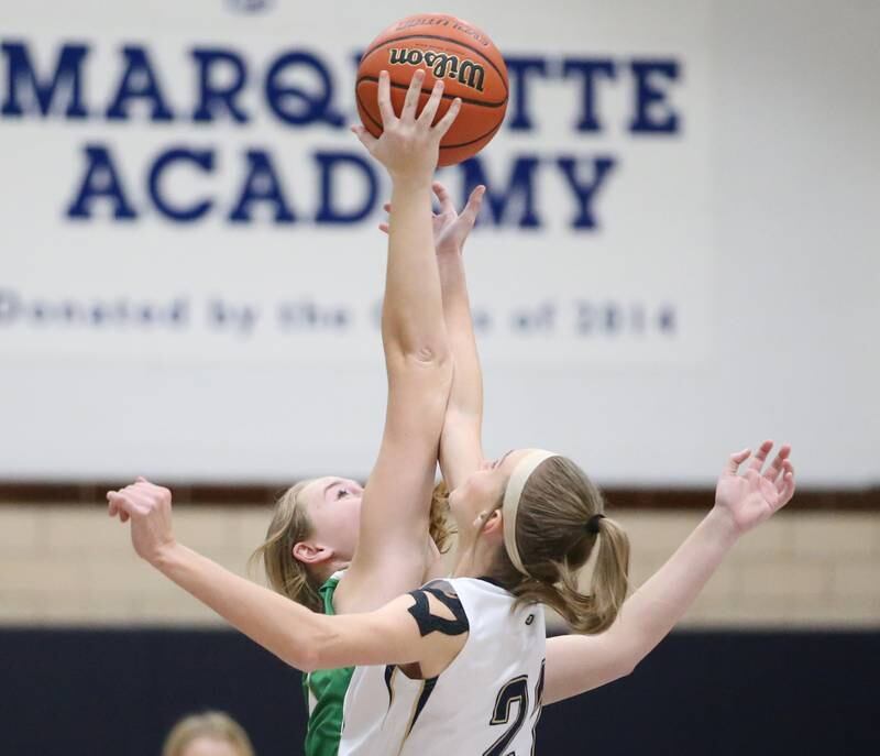 Seneca's Tessa Krull wins the opening tip over Marquette's Avery Durdan in Bader Gym on Monday, Jan. 23, 2023 at Marquette High School.