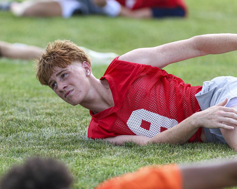Dillon Griffin stretches with the team at Oswego High School Football Practice, Monday, Aug 11, 2025  in Oswego.