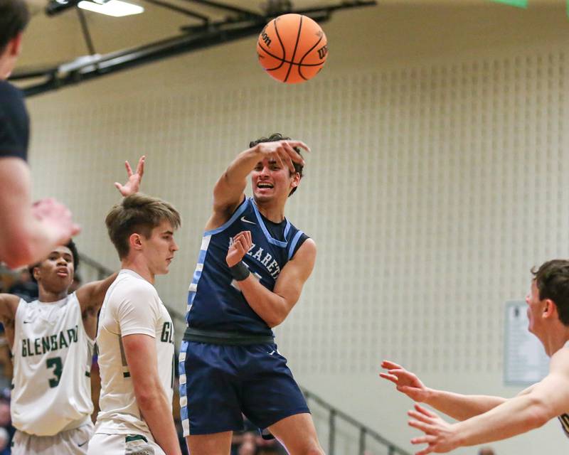 Nazareth's Oliver De santiago (11) makes a pass from the top of the key during their Jack Tosh Holiday Classic basketball tournament game between Nazareth vs Glenbard West. Thursday Dec 26, 2024 in Elmhurst.