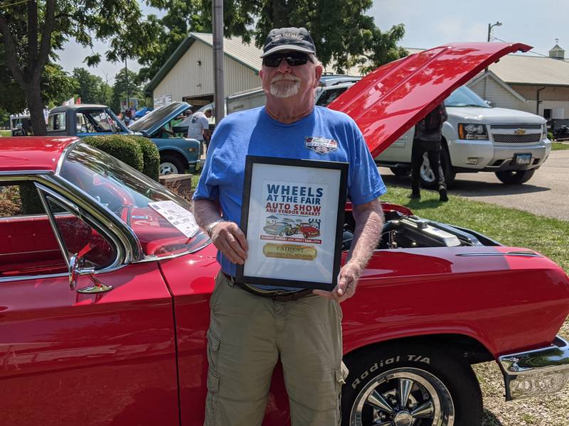 Montgomery resident Jim White was beaming with happiness after his 1962 Chevy Impala received the top prize – Fairest of the Kendall County Fair – during the Aug. 4 auto show at the Kendall County Fair.