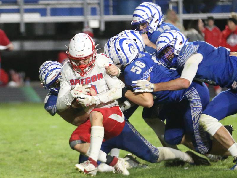 Oregon's cooper Johnson is taken down by a number of Princeton Tiger defenders during the Class 3A playoff game on Friday, Nov. 1, 2024 at Princeton High School.
