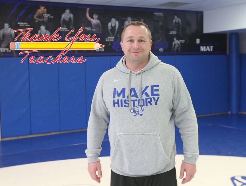 Princeton wrestling head coach Steve Amy poses for a photo in the wrestling room on Wednesday, March 12, 2025 at Princeton High School.