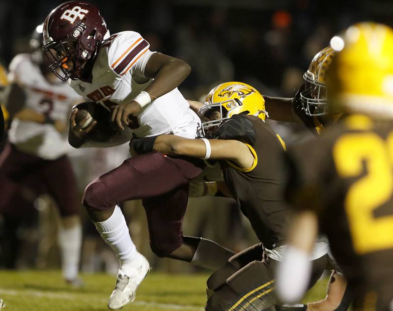 Jacobs' Juan Perez, right, tries to tackle Brother Rice's Marcus Brown during a IHSA Class 7A first round playoff football game Friday, Oct. 28, 2022, between Jacobs and Brother Rice at Jacobs High School in Algonquin.