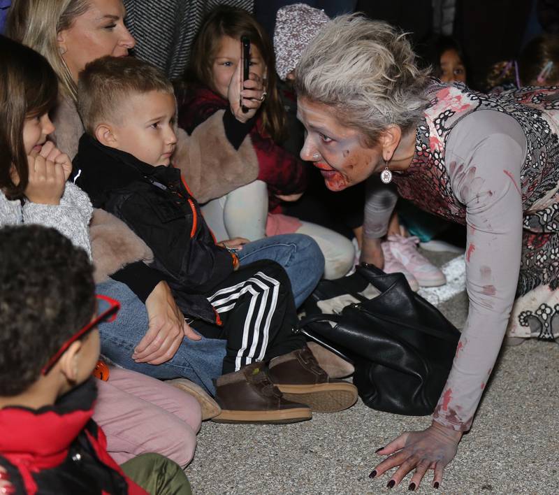 Amanda May portrays a zombie from Vargo’s Dance interacts with children at the Sixth Annual Thriller on 38 on Friday, Oct. 20, 2023 in Geneva.