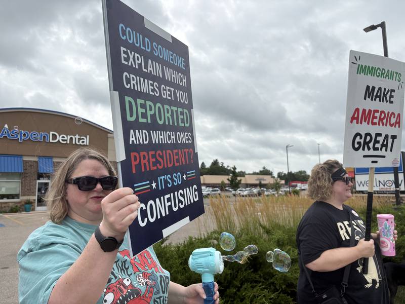 Jennifer Tooke blows bubbles at a protest in McHenry July 26, 2025.
