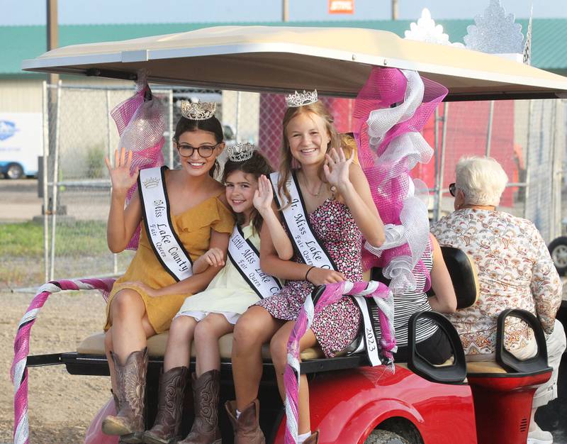 Newly crowned Lily Troyan, 18, of Lake Villa (Miss Lake County Fair Queen) Ellie Mahan, 8, of Libertyville (Little Miss) and Jenna Marasco, 13, of Lake Villa (Jr. Miss) take a ride around the fairgrounds after leaving the Grandstand Arena during the Lake County Fair at the Lake County Fairgrounds on Friday, July 28th in Grayslake.  
Photo by Candace H. Johnson for Shaw Local News Network