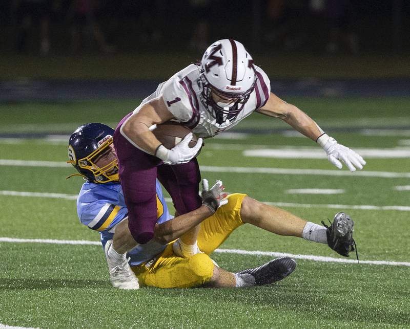 Sterling’s Wyatt Cassens hauls down Moline’s Elijah Warren Friday, Sept. 12, 2025.
