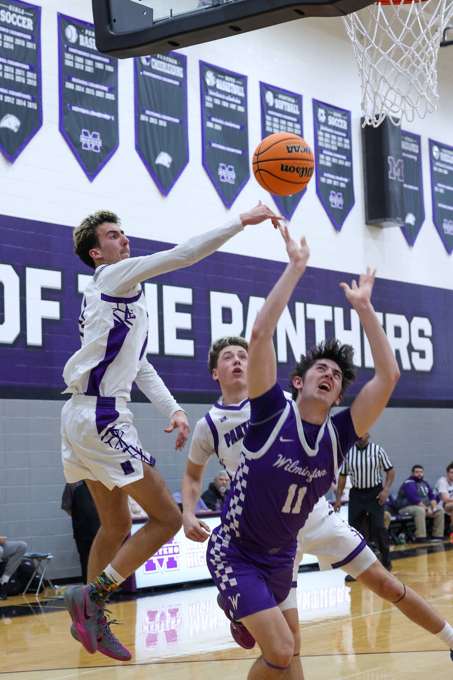 Wilmington's Ryan Kettman draws the foul under pressure from Manteno's Braden Campbell, left, and Dylan Polito during Wilmington's 60-35 victory over Manteno on Tuesday, Feb. 17, 2026.