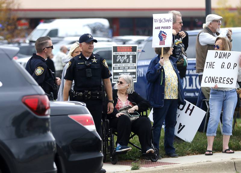 McHenry Police watch as protesters line Route 31 during a "No Kings” protest rally on Saturday, Oct. 18, 2025, in McHenry. The protest drew thousands of protesters to the area to protest the policies of President Donald Trump.